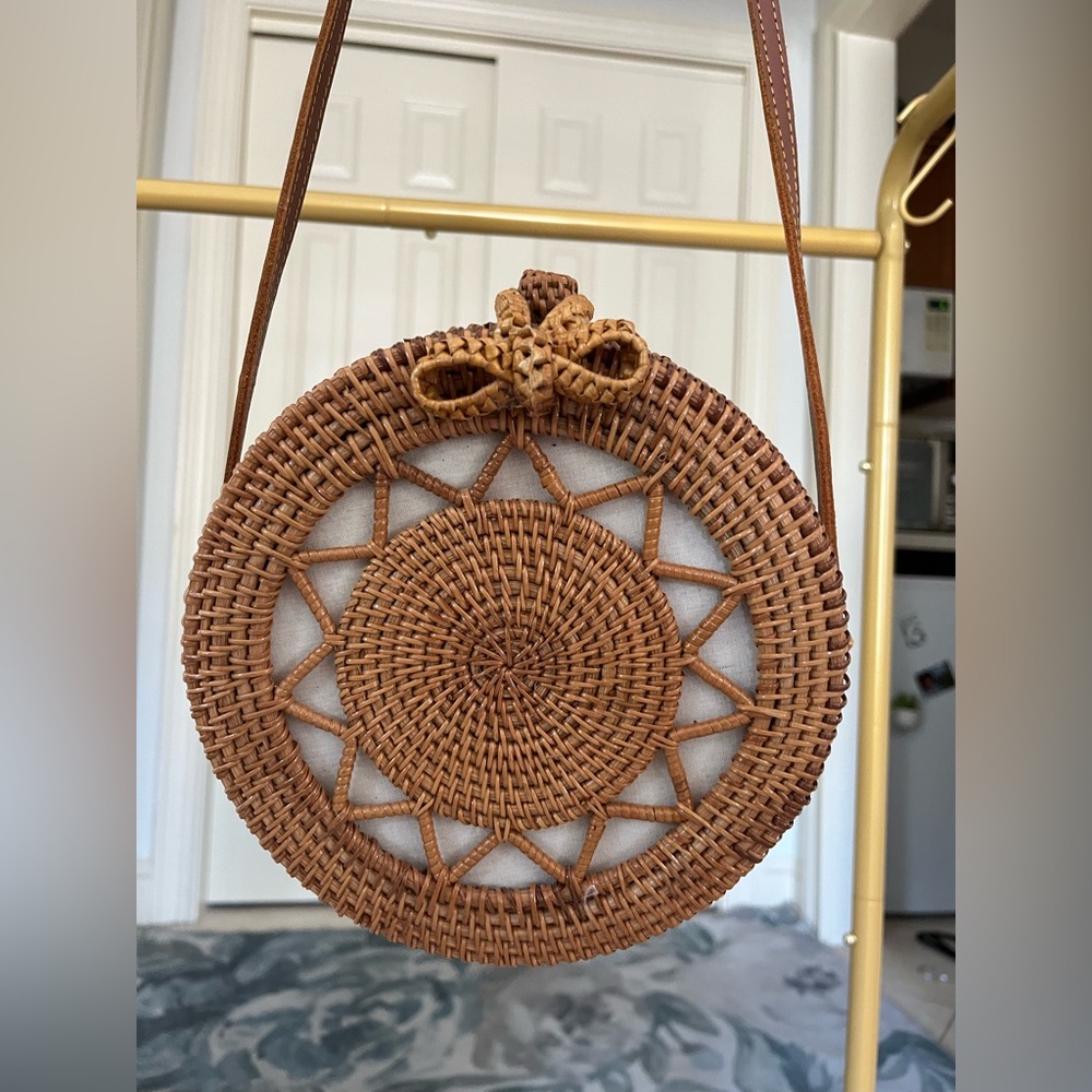 Very gently used rattan circle purse with long strap